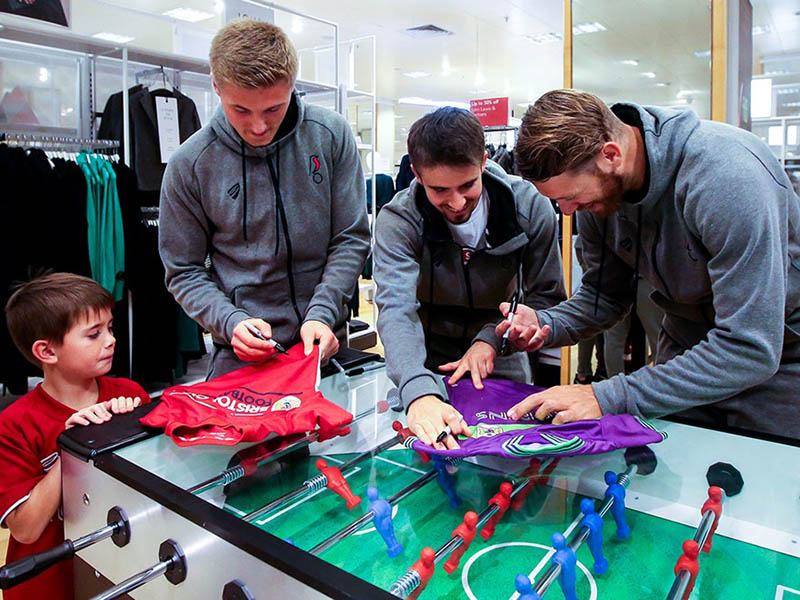 Bristol City players sign autographs for a very pleased fan